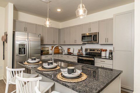 a kitchen with granite counter tops and stainless steel appliances